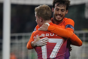 MOENCHENGLADBACH, GERMANY - NOVEMBER 23:   David Silva of Manchester City celebrates after scoring a goal to make it 1-1 with Kevin De Bruyne during the UEFA Champions League match between VfL Borussia Moenchengladbach and Manchester City FC at Borussia-P