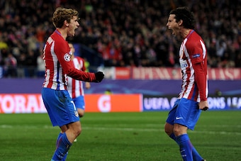 MADRID, SPAIN - NOVEMBER 23:  Antoine Griezmann of Atletico Madrid (L) celebrates scoring his sides second goal with Tiago of Atletico Madrid (R) during the UEFA Champions League Group D match between Club Atletico de Madrid and PSV Eindhoven at Vicente C