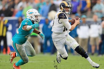 LOS ANGELES, CA - NOVEMBER 20:  Quarterback Jared Goff #16 of the Los Angeles Rams runs with the ball away from Spencer Paysinger #42 of the Miami Dolphins during the third quarter of the game at Los Angeles Coliseum on November 20, 2016 in Los Angeles, C