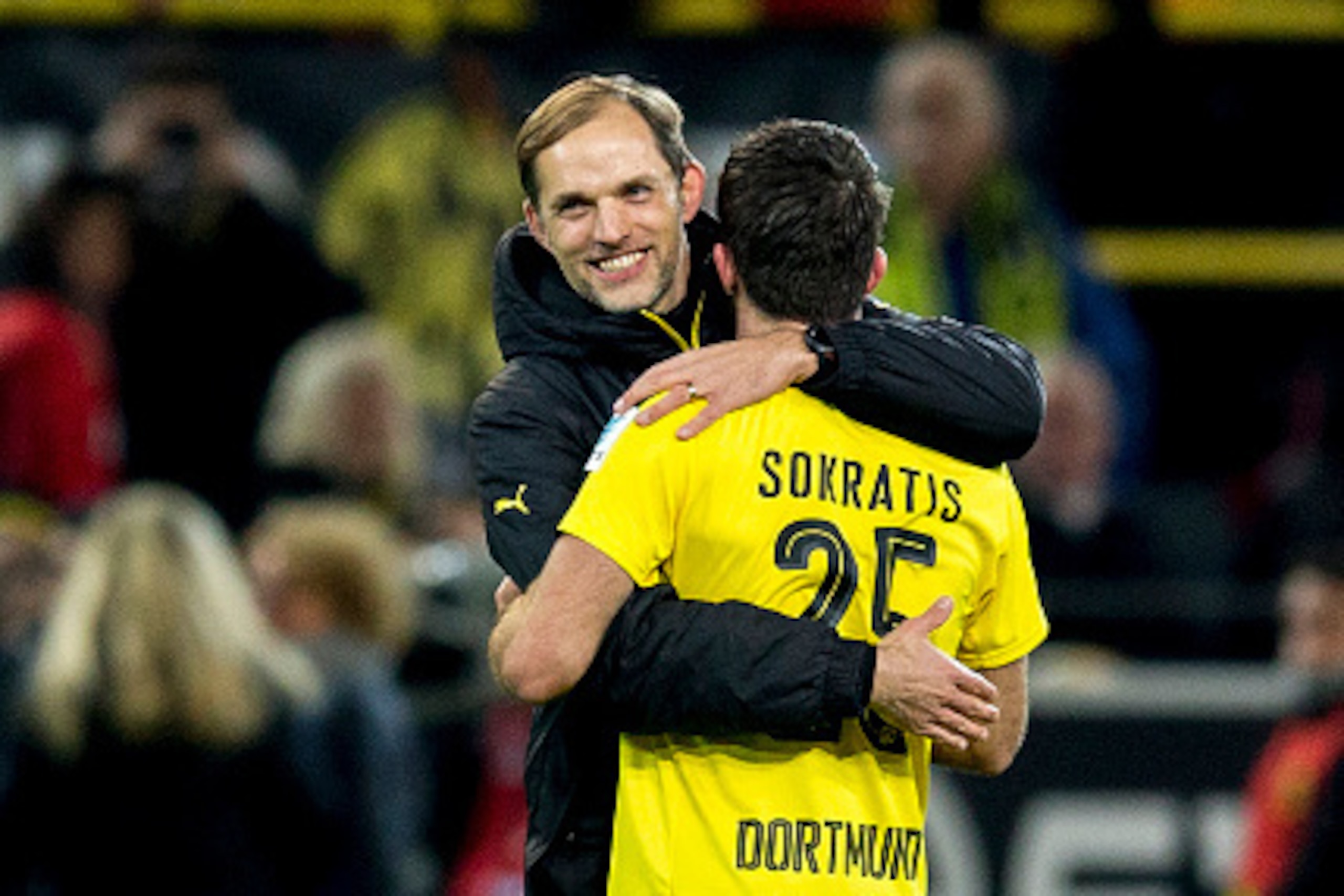 DORTMUND, GERMANY - NOVEMBER 19: Head coach Thomas Tuchel of Borussia Dortmund hugs Sokratis Papastathopoulos of Borussia Dortmund after winning the Bundesliga match between Borussia Dortmund and Bayern Muenchen at Signal Iduna Park on November 19, 2016 DORTMUND, GERMANY - NOVEMBER 19: Head coach Thomas Tuchel of Borussia Dortmund hugs Sokratis Papastathopoulos of Borussia Dortmund after winning the Bundesliga match between Borussia Dortmund and Bayern Muenchen at Signal Iduna Park on November 19, 2016