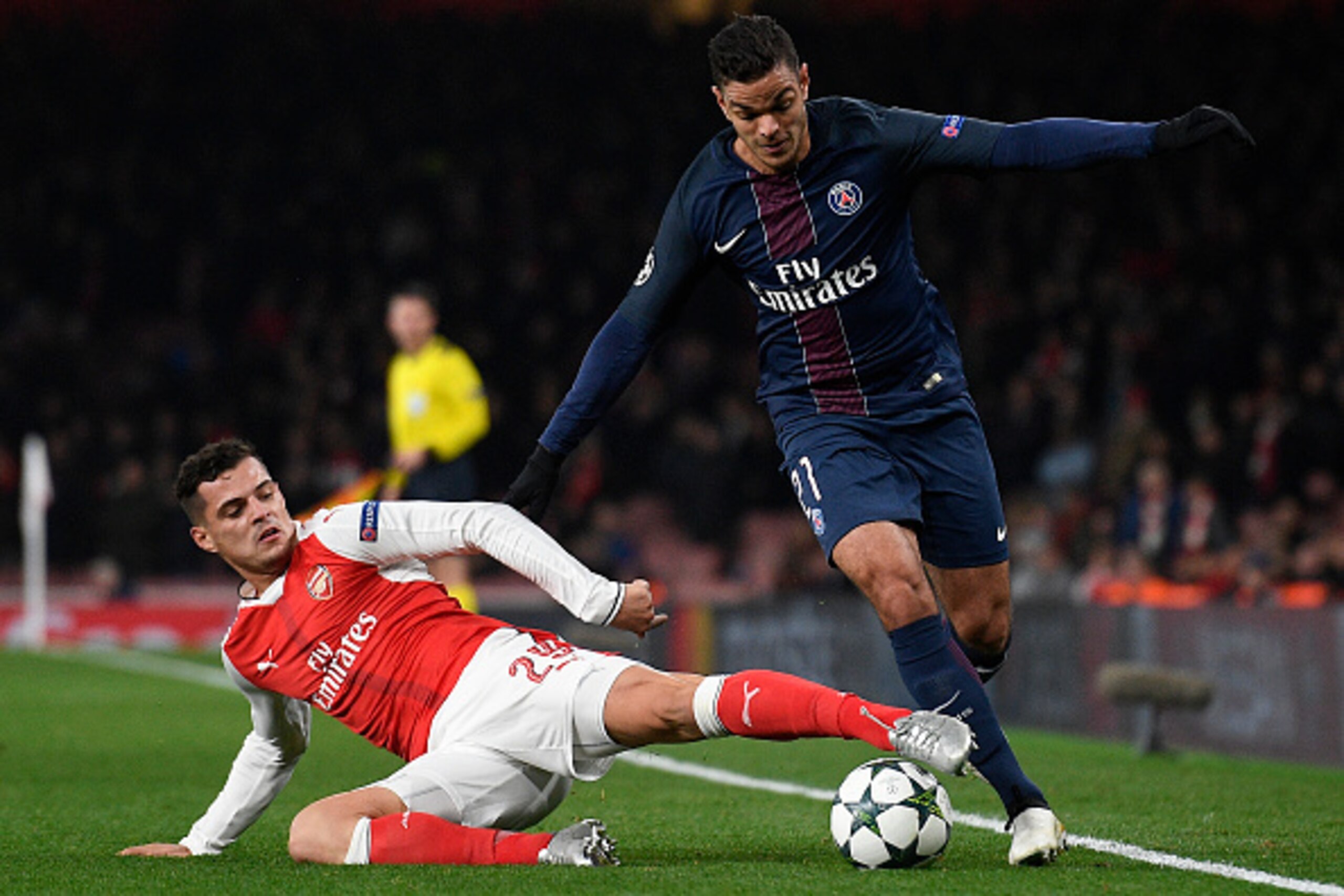 Arsenal's Swiss midfielder Granit Xhaka (L) tackles Paris Saint-Germain's French forward Hatem Ben Arfa (R) during the UEFA Champions League group A football match between Arsenal and Paris Saint-Germain at the Emirates Stadium in London on November 23, 2