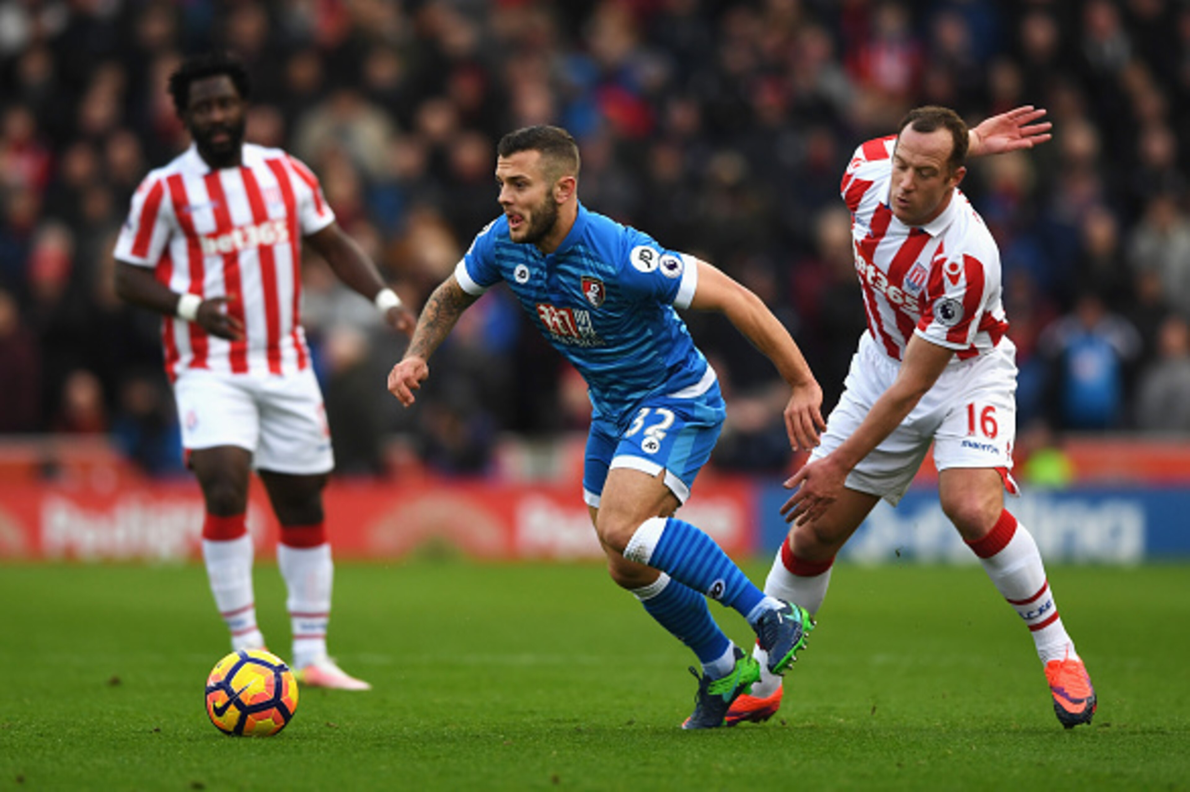 STOKE ON TRENT, ENGLAND - NOVEMBER 19:  Jack Wilshere of AFC Bournemouth (L) is tackled by Charlie Adam of Stoke City (R) during the Premier League match between Stoke City and AFC Bournemouth at Bet365 Stadium on November 19, 2016 in Stoke on Trent, Engl