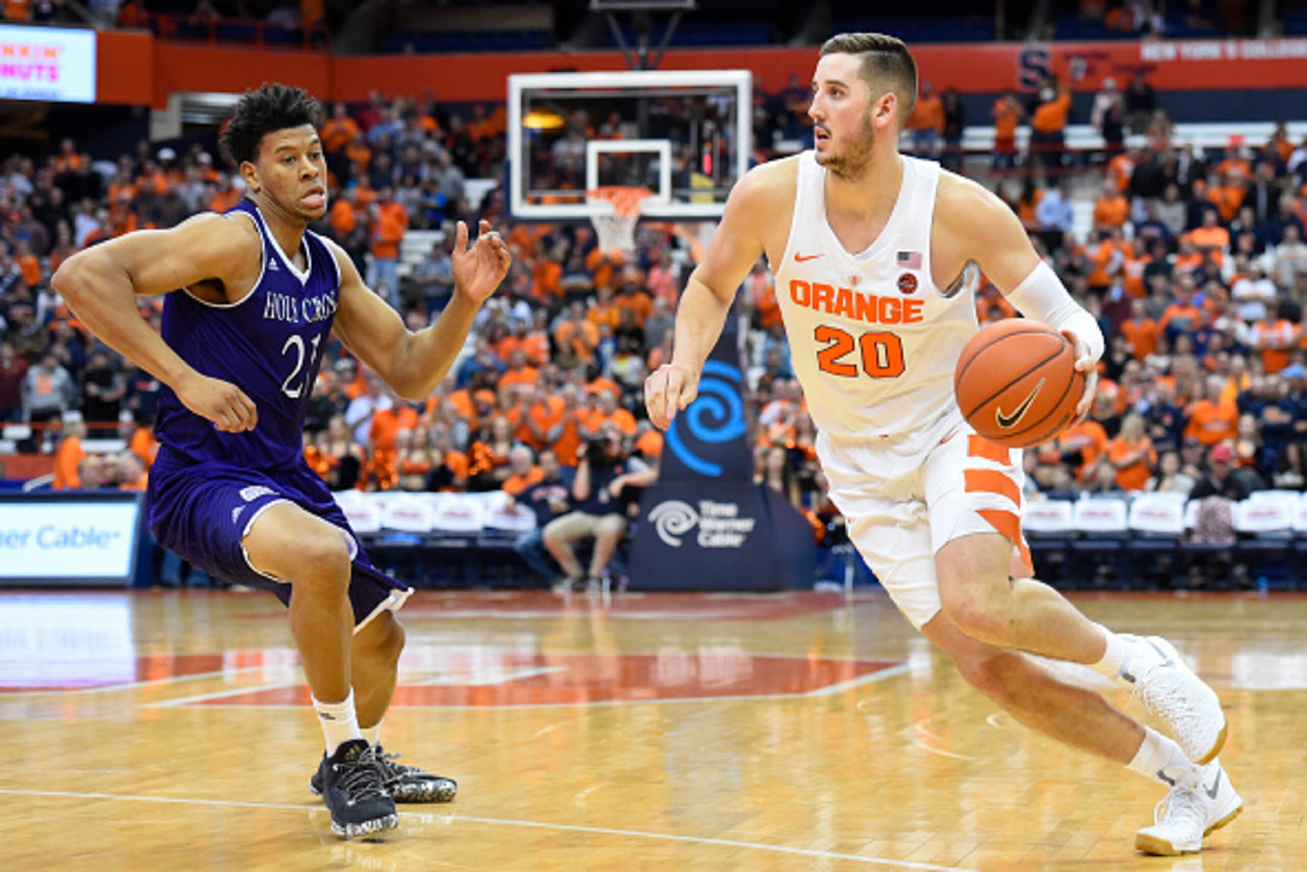 SYRACUSE, NY - NOVEMBER 15: Tyler Lydon #20 of the Syracuse Orange drives to the basket around Malachi Alexander #21 of the Holy Cross Crusaders during the second half at the Carrier Dome on November 15, 2016 in Syracuse, New York. Syracuse defeated Holy SYRACUSE, NY - NOVEMBER 15: Tyler Lydon #20 of the Syracuse Orange drives to the basket around Malachi Alexander #21 of the Holy Cross Crusaders during the second half at the Carrier Dome on November 15, 2016 in Syracuse, New York. Syracuse defeated Holy