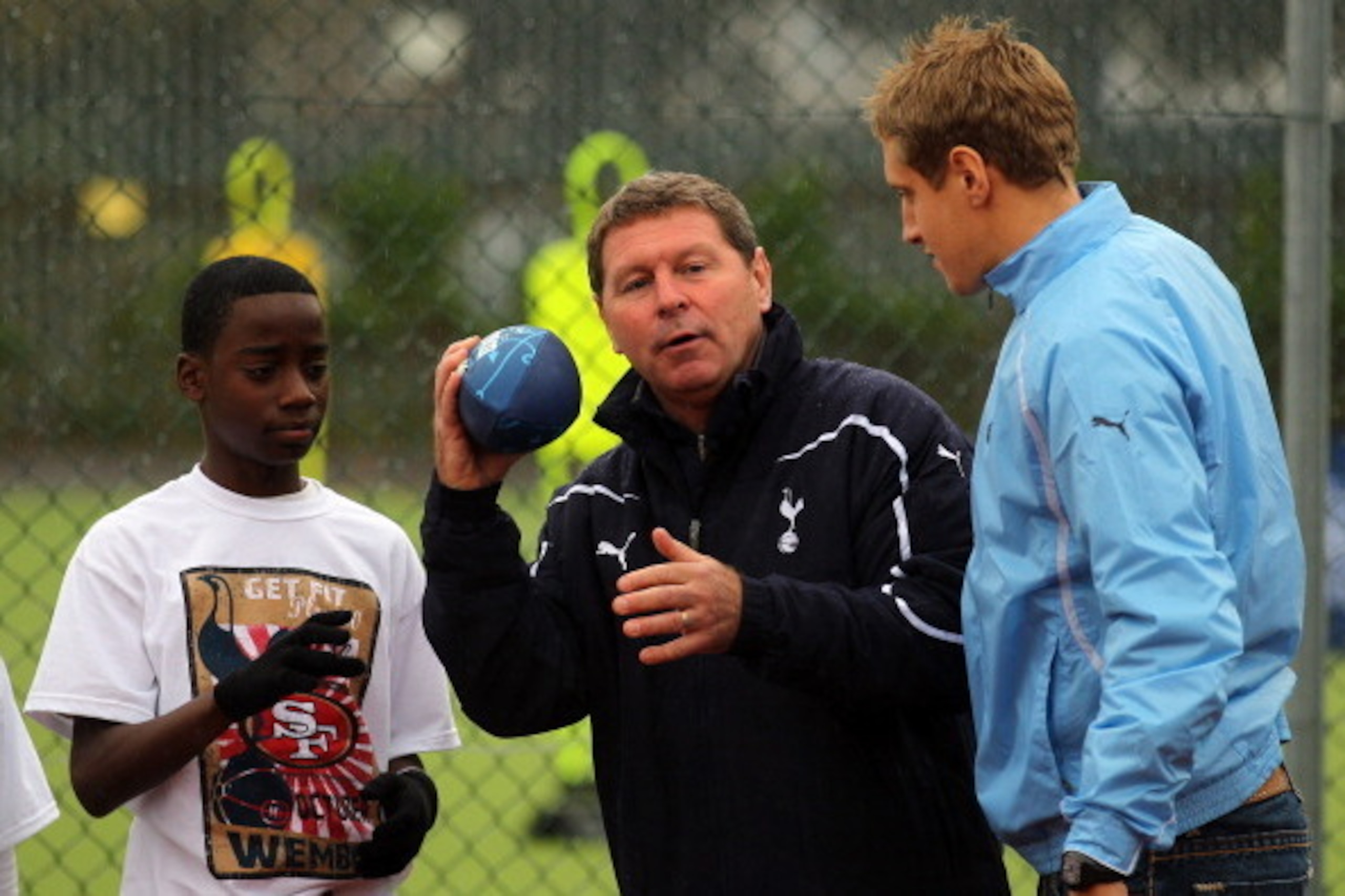 LONDON, ENGLAND - OCTOBER 26: Clive Allen and Michael Dawson of Tottenham Hotspur give instruction during the Football And Football community coaching clinic with Tottenham Hotspur and San Francisco 49ers on October 26, 2010 in London, England.  (Photo by