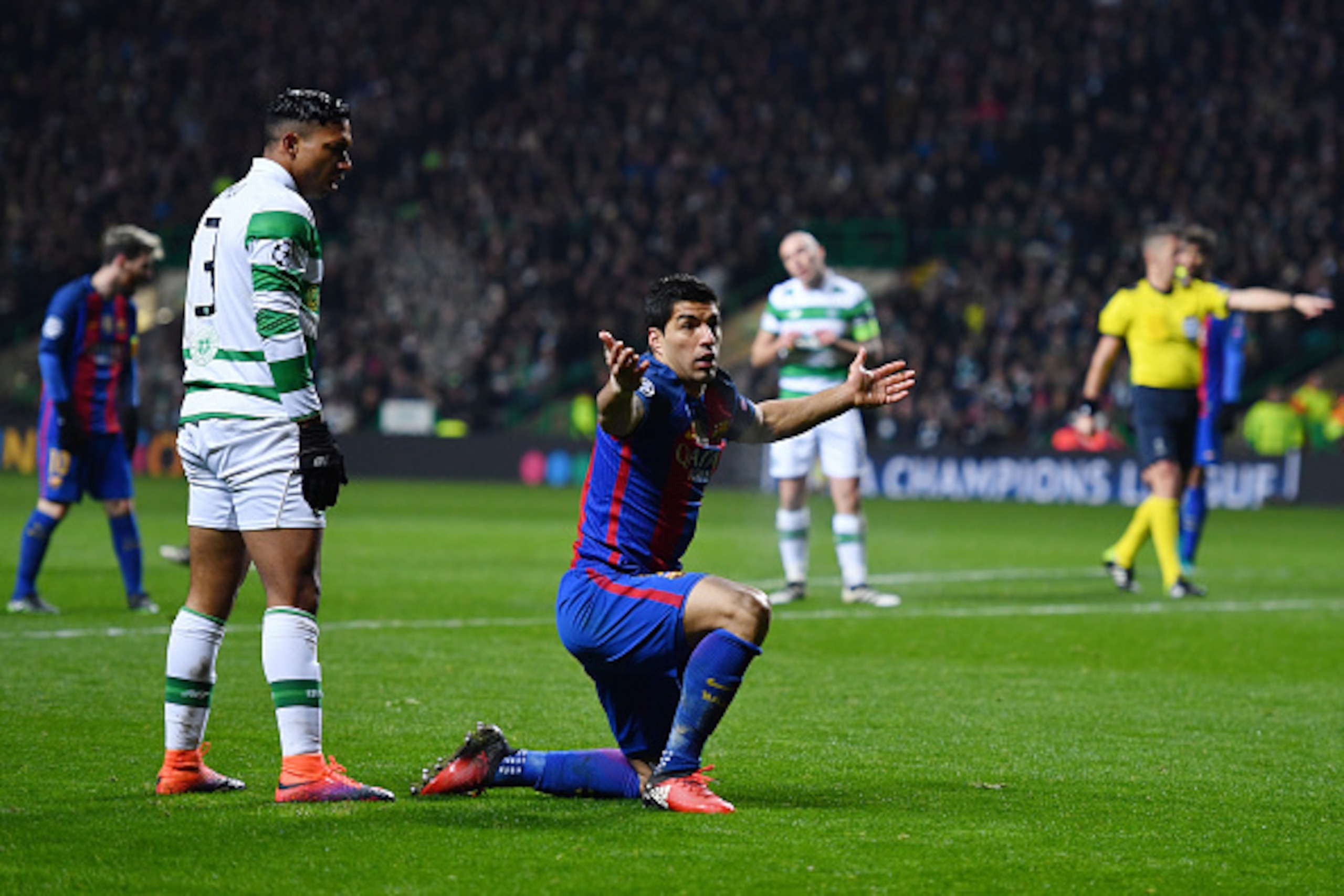 GLASGOW, SCOTLAND - NOVEMBER 23:  Emilio Izaguirre of Celtic (L) fouls Luis Suarez of Barcelona (R) for a Barcelona penalty during the UEFA Champions League Group C match between Celtic FC and FC Barcelona at Celtic Park Stadium on November 23, 2016 in Gl