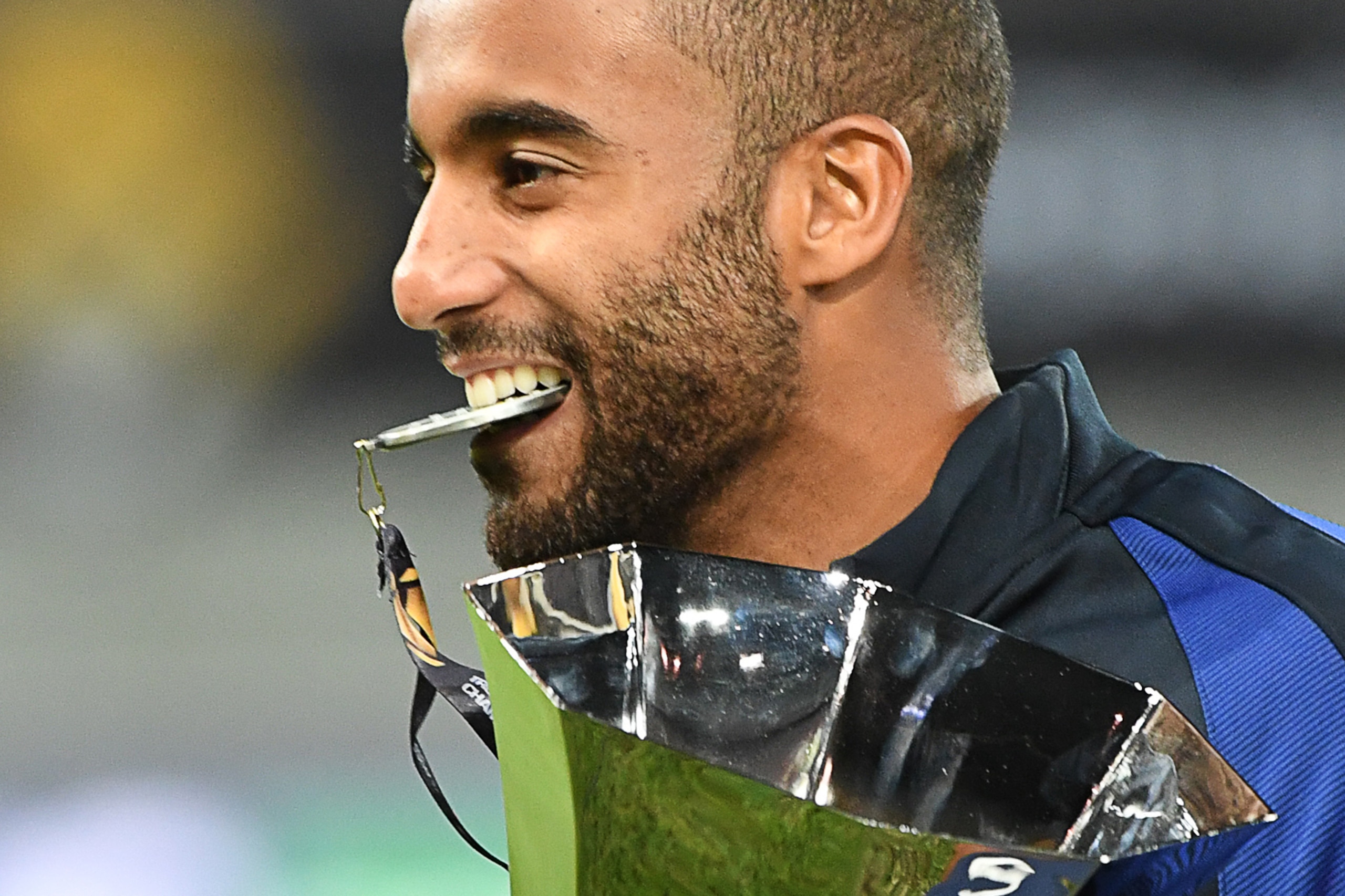 Paris Saint-Germain's Brazilian midfielder Lucas Moura celebrates with the trophy after winning the French Supercup Champions trophy (Trophée des Champions) football match Paris Saint-Germain vs Olympique Lyonnais in Klagenfurt, on August 6, 2016. / AFP /