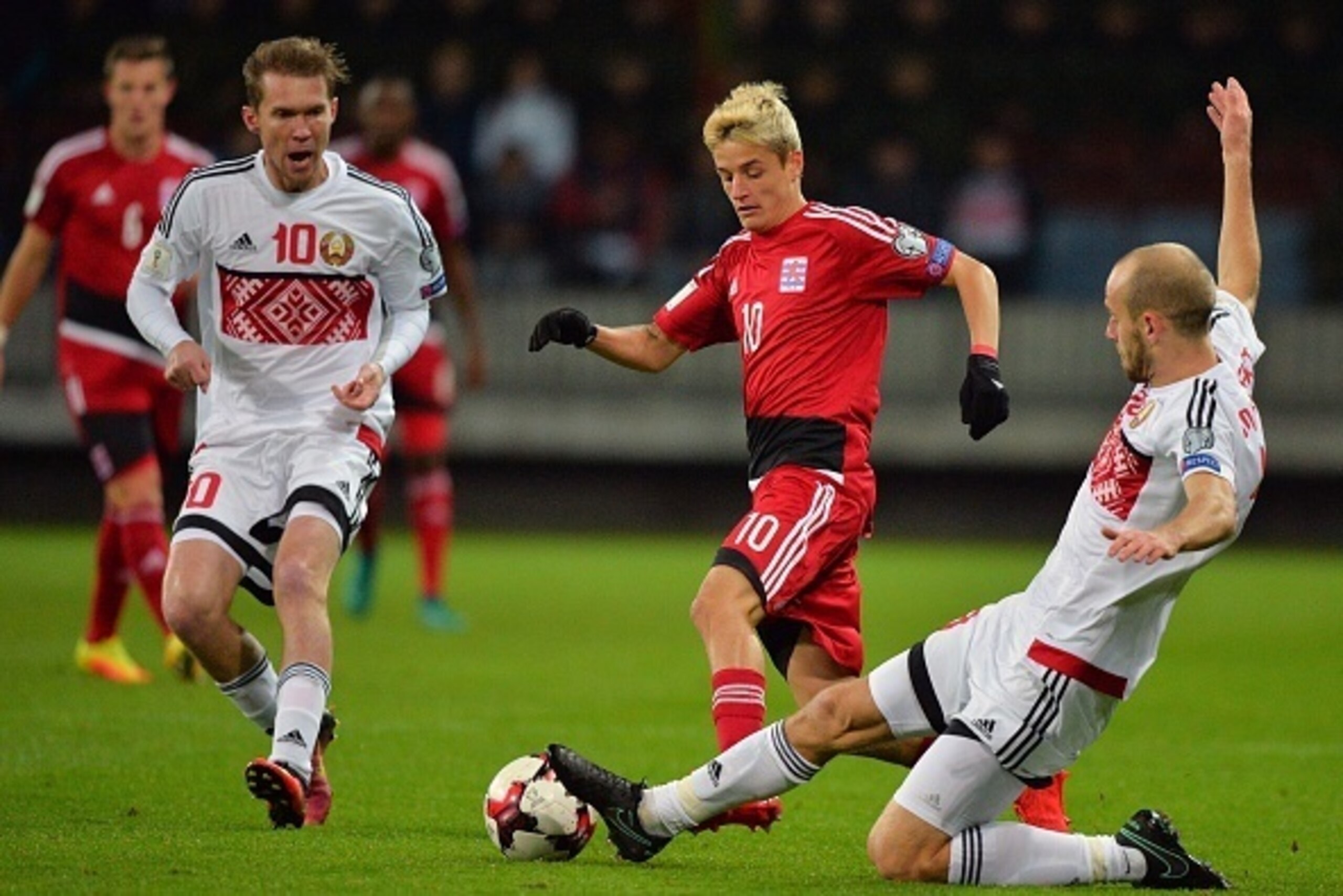 Belarus' Aleksandr Hleb (L) and Belarus' Ivan Maevski (R) vie with Luxembourg's Vincent Thill during the WC 2018 football qualification match between Belarus and Luxembourg in Borisov, outside Minsk, on October 10, 2016.  / AFP / MAXIM MALINOVSKY        (