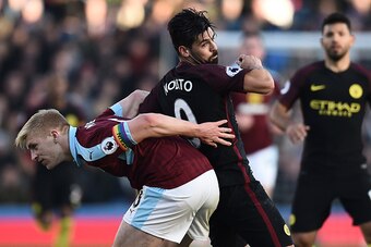Burnley's captain Ben Mee (L) wearing a rainbow armband vies with Manchester City's Spanish midfielder Nolito during the English Premier League football match between Burnley and Manchester City at Turf Moor in Burnley, north west England on November 26, 