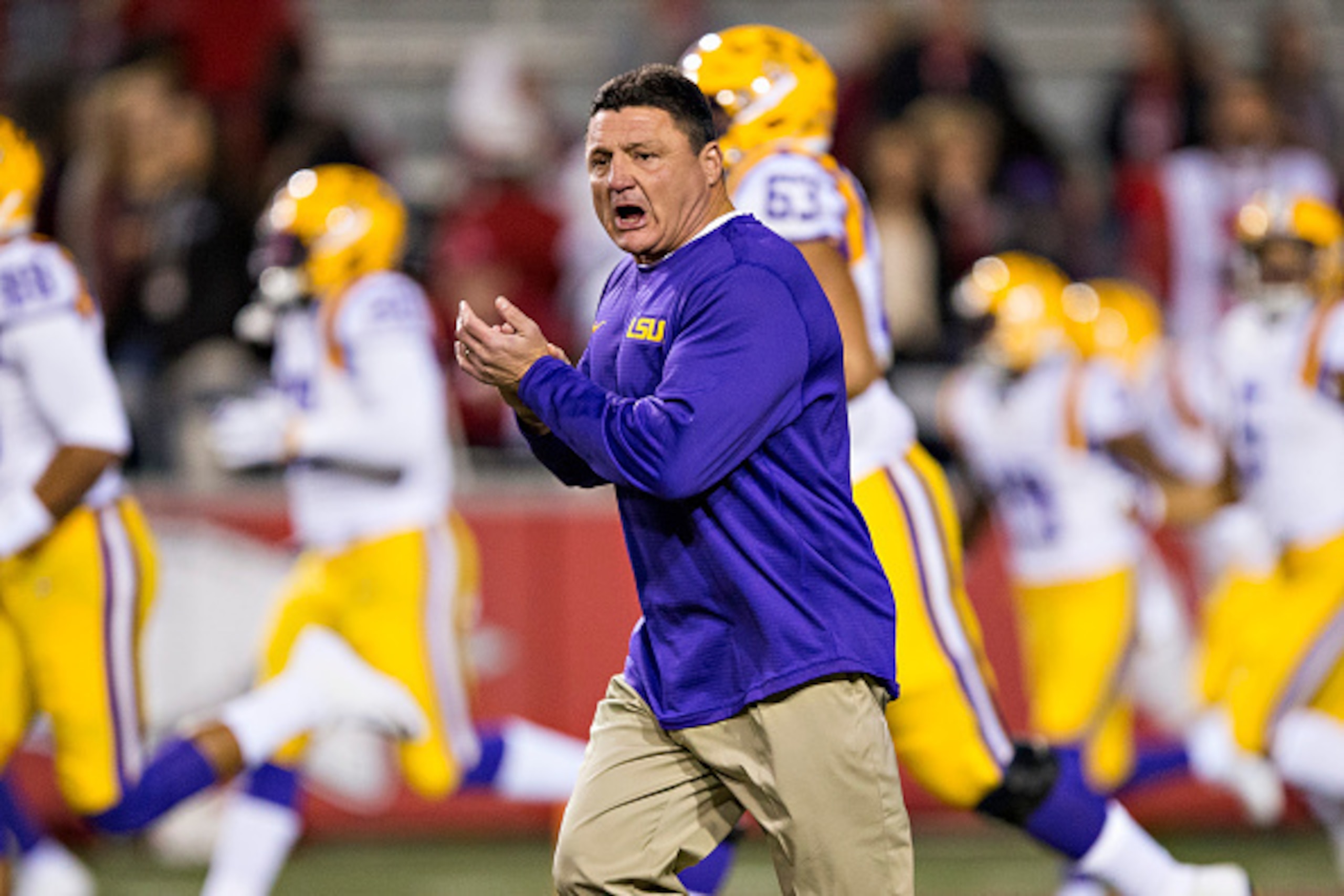 FAYETTEVILLE, AR - NOVEMBER 12:  Head Coach Ed Orgeron of the LSU Tigers leads his team onto the field before a game against the Arkansas Razorbacks at Razorback Stadium on November 12, 2016 in Fayetteville, Arkansas.  The Tigers defeated the Razorbacks 3