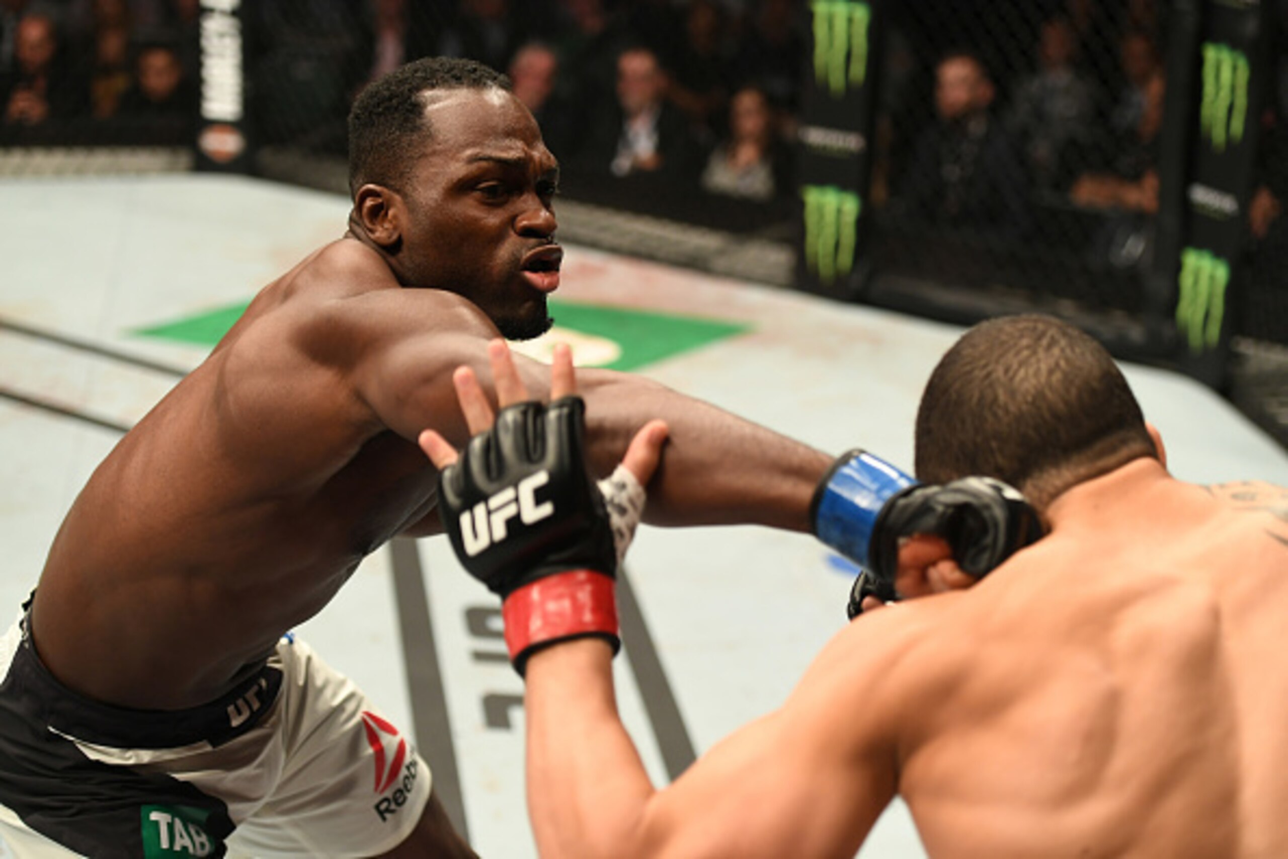 MELBOURNE, AUSTRALIA - NOVEMBER 27:   (L-R) Derek Brunson punches Robert Whittaker of New Zealand in their middleweight bout during the UFC Fight Night event at Rod Laver Arena on November 27, 2016 in Melbourne, Australia. (Photo by Jeff Bottari/Zuffa LLC