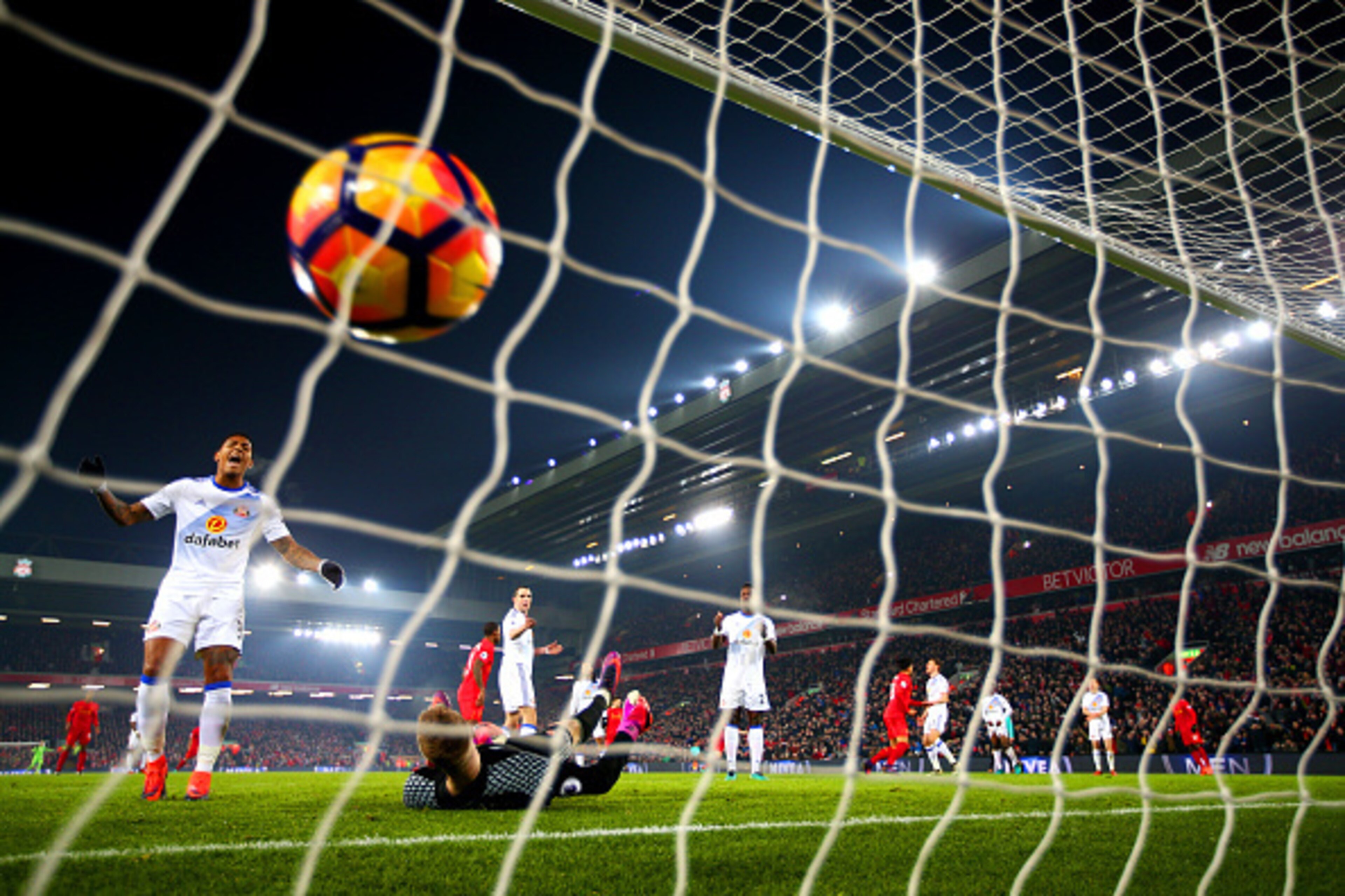 LIVERPOOL, ENGLAND - NOVEMBER 26: Jordan Pickford of Sunderland dives in vain as Divock Origi of Liverpool scores his team's first goal during the Premier League match between Liverpool and Sunderland at Anfield on November 26, 2016 in Liverpool, England LIVERPOOL, ENGLAND - NOVEMBER 26: Jordan Pickford of Sunderland dives in vain as Divock Origi of Liverpool scores his team's first goal during the Premier League match between Liverpool and Sunderland at Anfield on November 26, 2016 in Liverpool, England