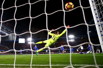 LONDON, ENGLAND - NOVEMBER 26: Hugo Lloris of Tottenham Hotspur dives in vain as Christian Eriksen (4th R) of Tottenham Hotspur scores the opening goal during the Premier League match between Chelsea and Tottenham Hotspur at Stamford Bridge on November 26