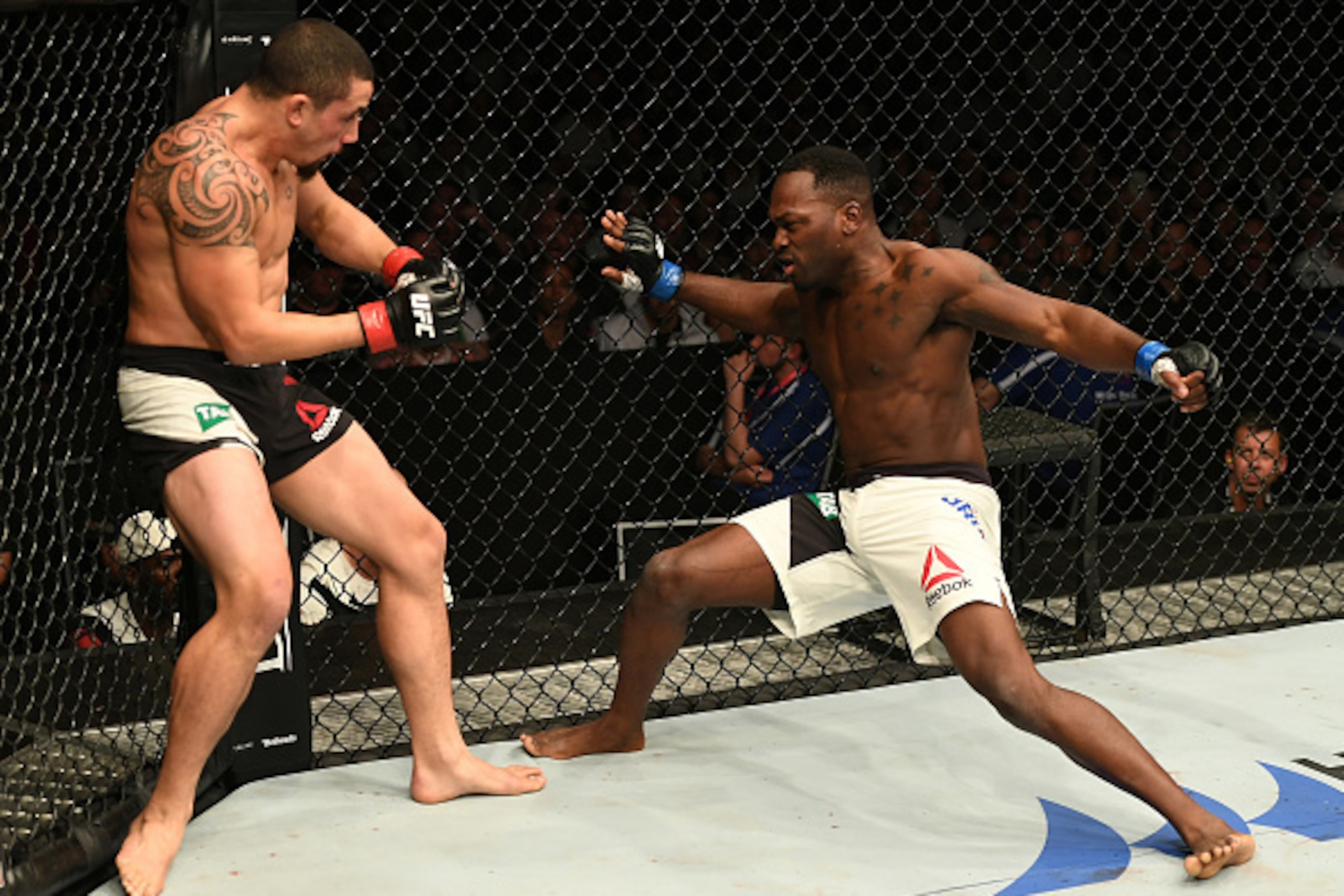 MELBOURNE, AUSTRALIA - NOVEMBER 27: (L-R) Robert Whittaker of New Zealand stuns Derek Brunson with a punch in their middleweight bout during the UFC Fight Night event at Rod Laver Arena on November 27, 2016 in Melbourne, Australia. (Photo by Jeff Bottar MELBOURNE, AUSTRALIA - NOVEMBER 27: (L-R) Robert Whittaker of New Zealand stuns Derek Brunson with a punch in their middleweight bout during the UFC Fight Night event at Rod Laver Arena on November 27, 2016 in Melbourne, Australia. (Photo by Jeff Bottar