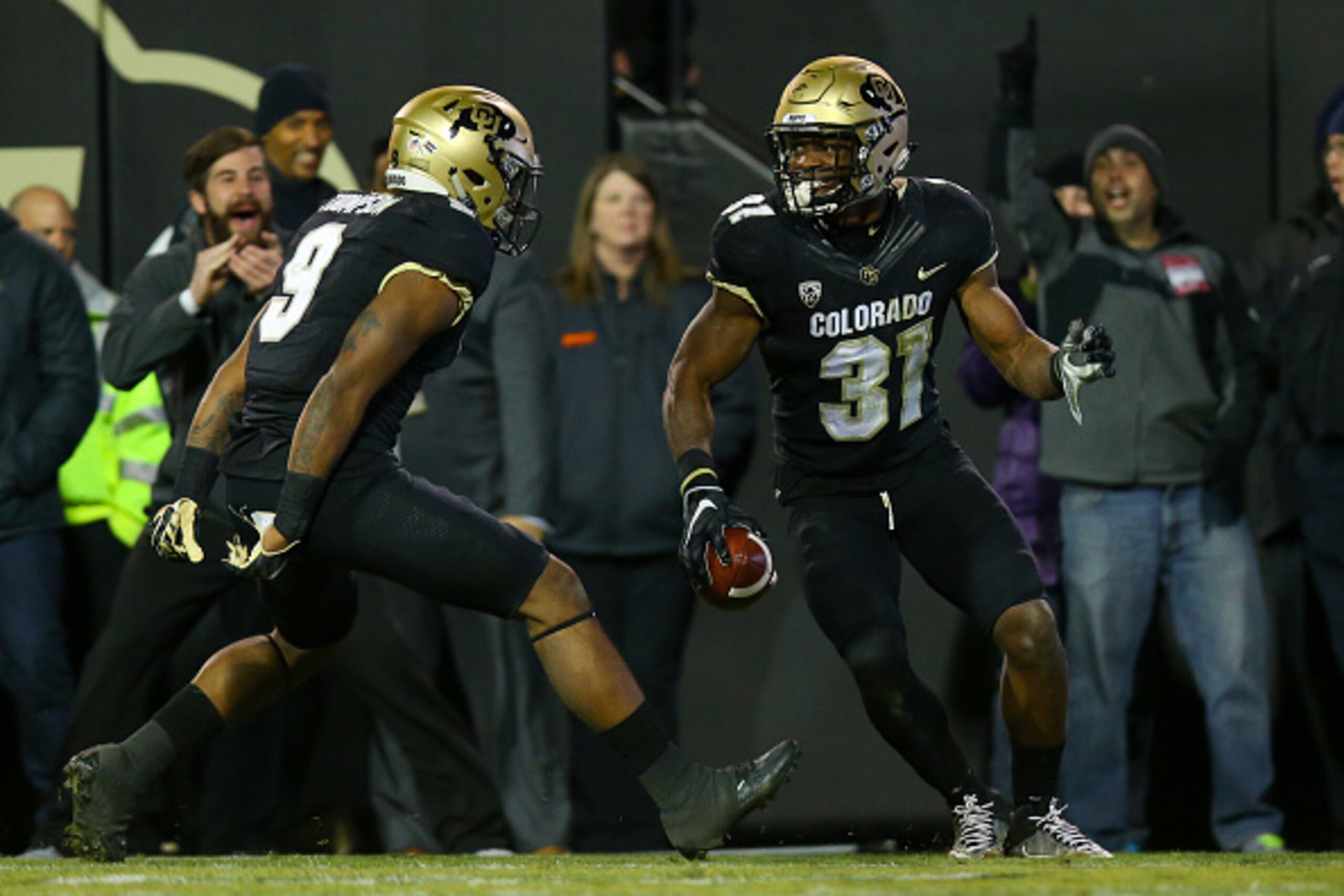 BOULDER, CO - NOVEMBER 26:  Linebacker Kenneth Olugbode #31 of the Colorado Buffaloes celebrates his fumble recovery and return for a touchdown with defensive back Tedric Thompson #9 during the fourth quarter against the Utah Utes at Folsom Field on Novem