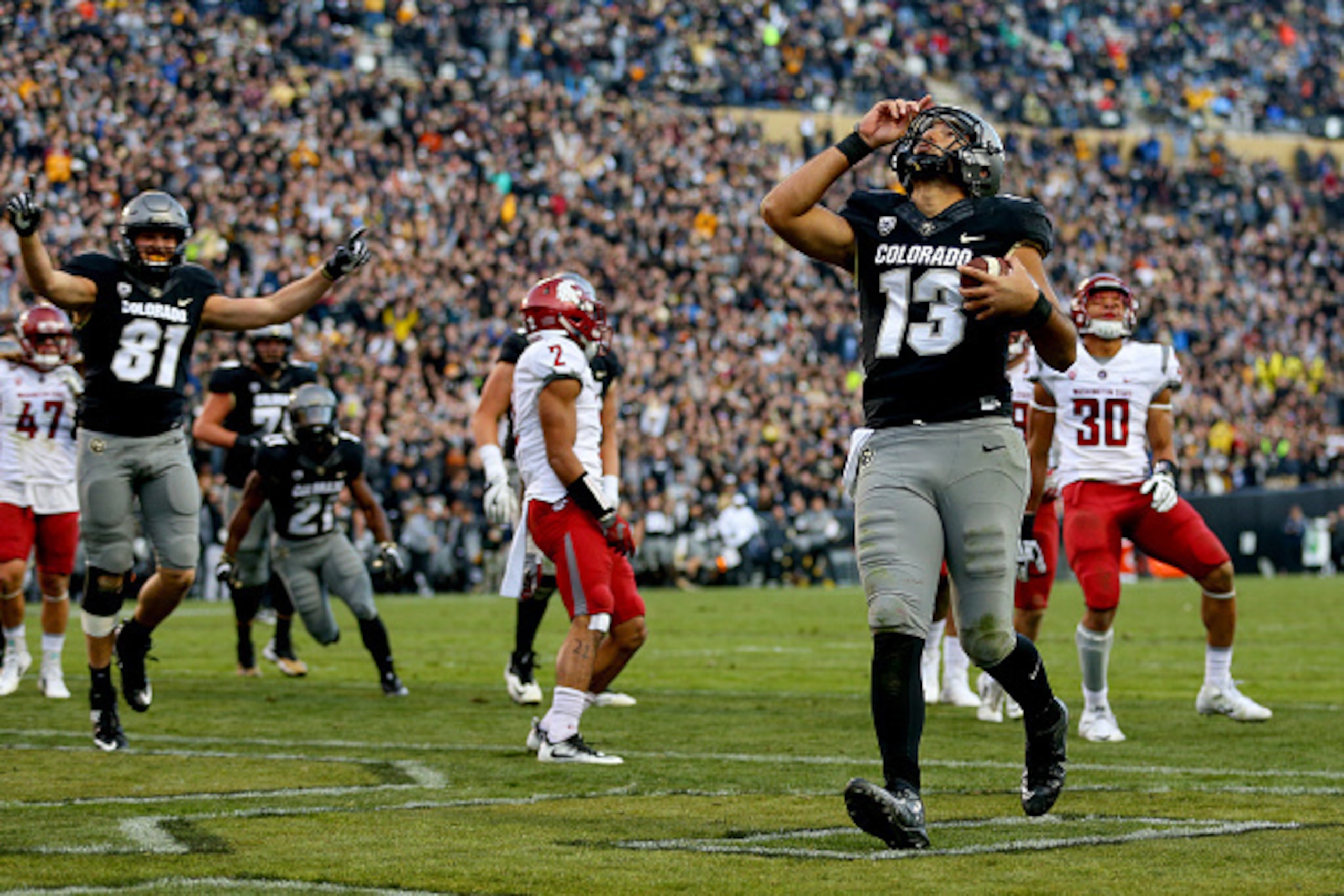 BOULDER, CO - NOVEMBER 19:  Quarterback Sefo Liufau #13 of the Colorado Buffaloes celebrates his third quarter touchdown against the Washington State Cougars at Folsom Field on November 19, 2016 in Boulder, Colorado. Colorado defeated Washington State 38-