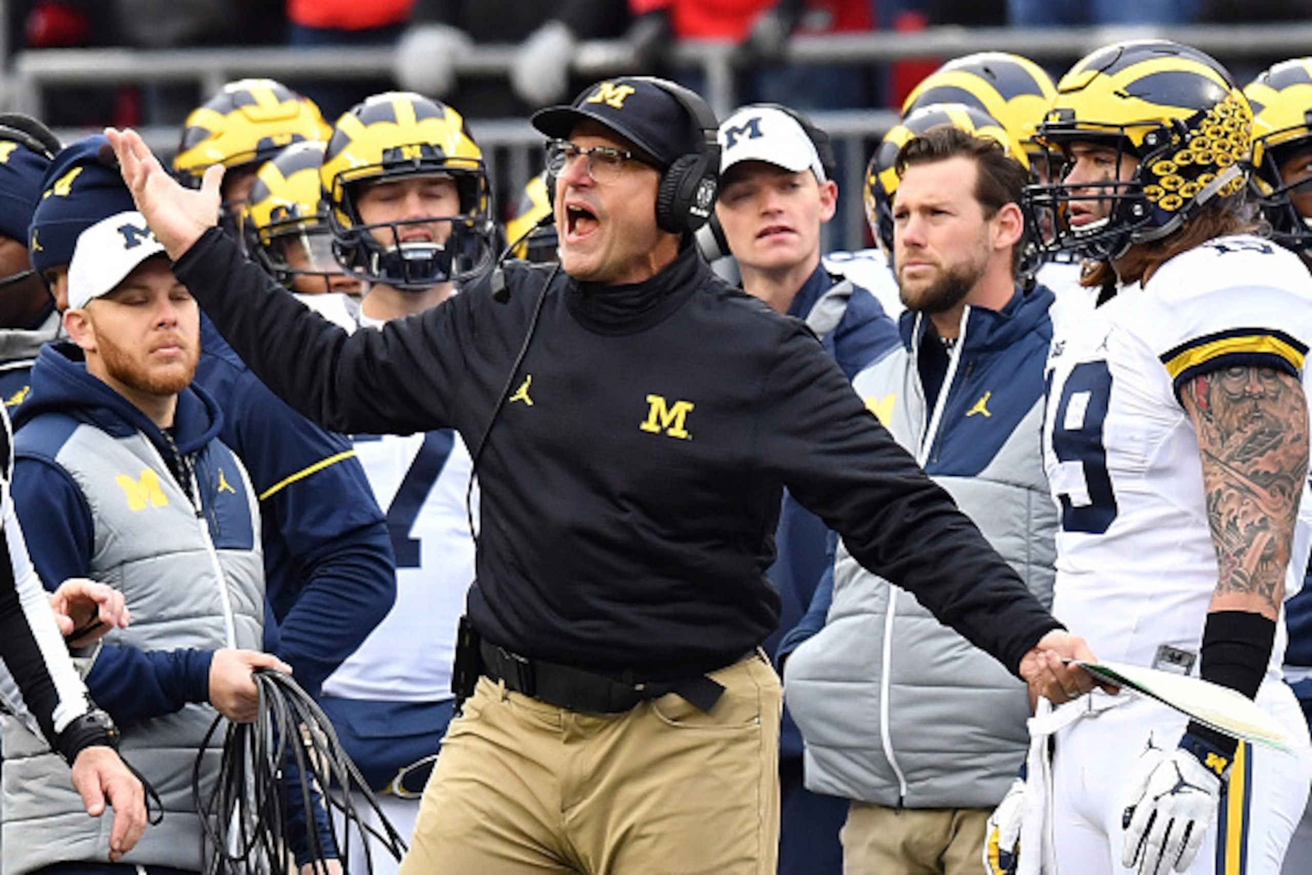 COLUMBUS, OH - NOVEMBER 26:   Head coach Jim Harbaugh of the Michigan Wolverines argues a call on the sideline during the second half against the Ohio State Buckeyes at Ohio Stadium on November 26, 2016 in Columbus, Ohio.  (Photo by Jamie Sabau/Getty Imag