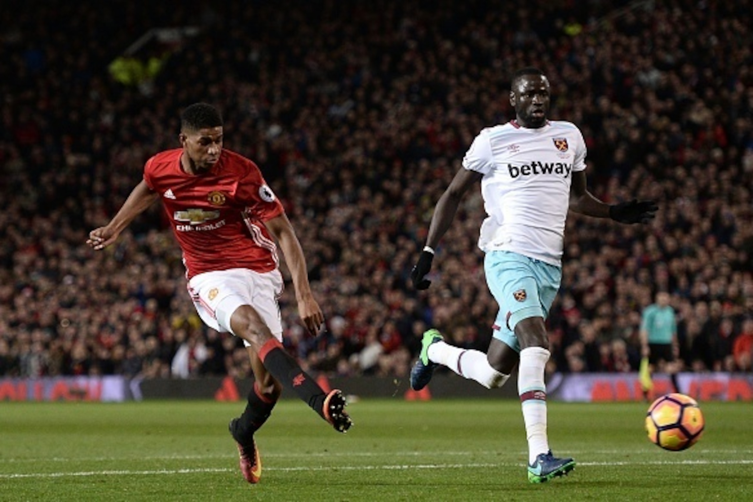 Manchester United's English striker Marcus Rashford (L) shoots in a one-on-one with the goalkeeper but sees his shot saved during the English Premier League football match between Manchester United and West Ham United at Old Trafford in Manchester, north 