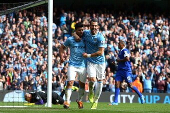 MANCHESTER, ENGLAND - OCTOBER 05:  Sergio Aguero of Manchester City celebrates with teammate Alvaro Negredo (R) after scoring his team's third goal from the penalty spot during the Barclays Premier League match between Manchester City and Everton at Etiha