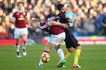 BURNLEY, ENGLAND - NOVEMBER 26: Ben Mee of Burnley and Nolito of Manchester City compete for the ball during the Premier League match between Burnley and Manchester City at Turf Moor on November 26, 2016 in Burnley, England.  (Photo by Alex Livesey/Getty