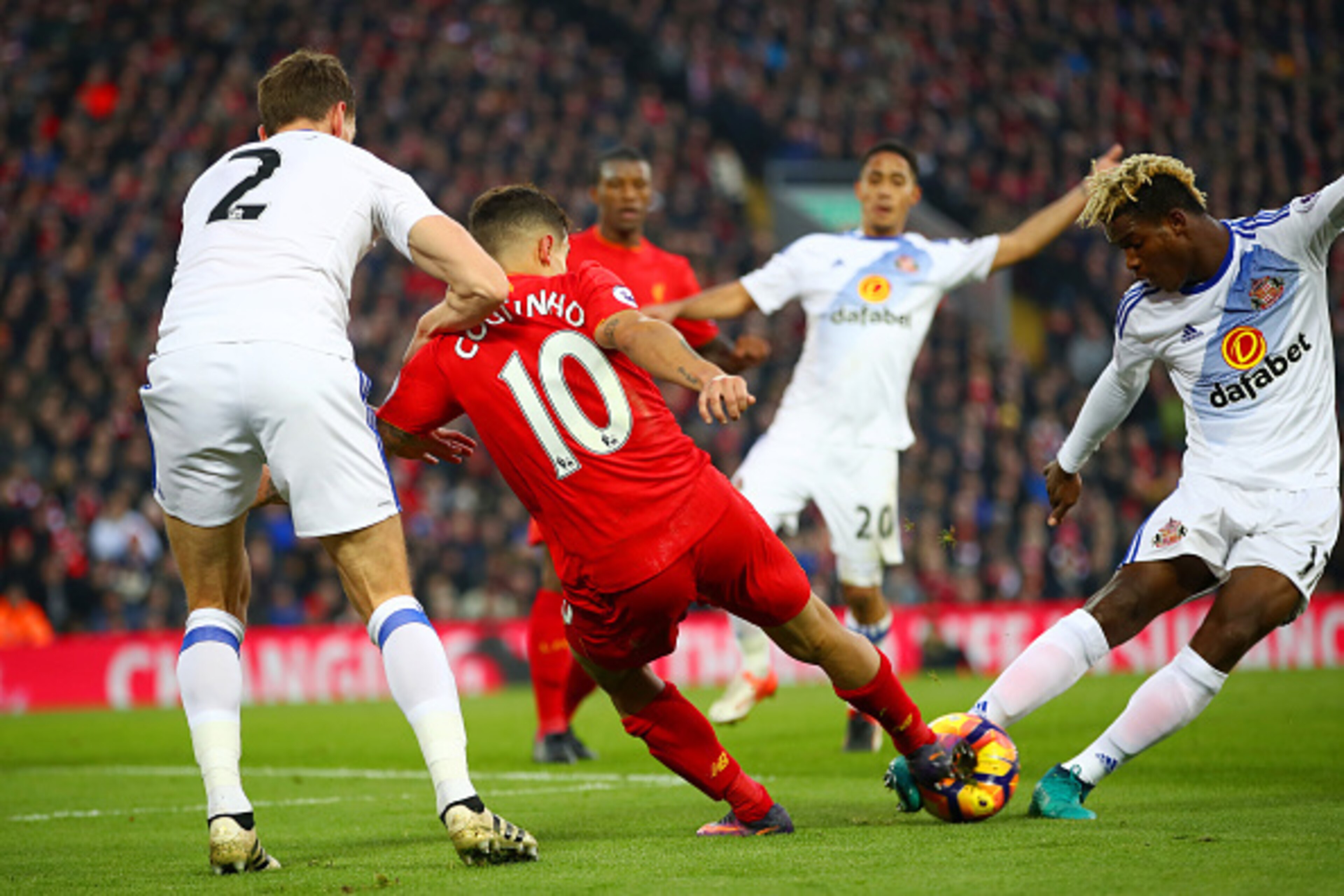 LIVERPOOL, ENGLAND - NOVEMBER 26: Dider Ndong of Sunderland and Philippe Coutinho of Liverpool compete for the ball during the Premier League match between Liverpool and Sunderland at Anfield on November 26, 2016 in Liverpool, England.  (Photo by Clive Br