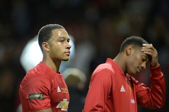 Manchester United's Dutch midfielder Memphis Depay (L) and Manchester United's French striker Anthony Martial (R) leave the pitch at the end of the friendly Wayne Rooney testimonial football match between Manchester United and Everton at Old Trafford in M