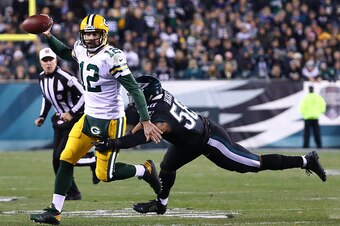 PHILADELPHIA, PA - NOVEMBER 28:  Aaron Rodgers #12 of the Green Bay Packers scrambles with the ball against Jordan Hicks #58 of the Philadelphia Eagles in the third quarter at Lincoln Financial Field on November 28, 2016 in Philadelphia, Pennsylvania. (Ph