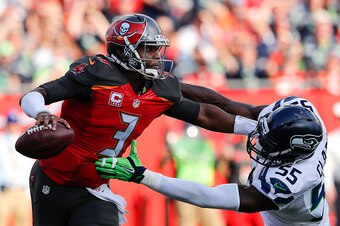 TAMPA, FL - NOVEMBER 27: Quarterback Jameis Winston #3 of the Tampa Bay Buccaneers gives Defensive End Frank Clark #55 a stiff arm during the game against the Seattle Seahawks at Raymond James Stadium on November 27, 2016 in Tampa, Florida. The Bucs defea