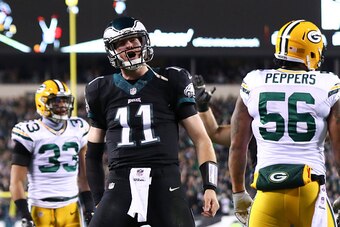 PHILADELPHIA, PA - NOVEMBER 28: Carson Wentz #11 of the Philadelphia Eagles reacts in front of Julius Peppers #56 and Micah Hyde #33 of the Green Bay Packers after a touchdown in the first quarter at Lincoln Financial Field on November 28, 2016 in Philade