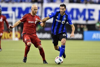 MONTREAL, QC - NOVEMBER 22:  Ignacio Piatti #10 of the Montreal Impact defends the ball against Michael Bradley #4 of the Toronto FC during leg one of the MLS Eastern Conference finals at Olympic Stadium on November 22, 2016 in Montreal, Quebec, Canada.  