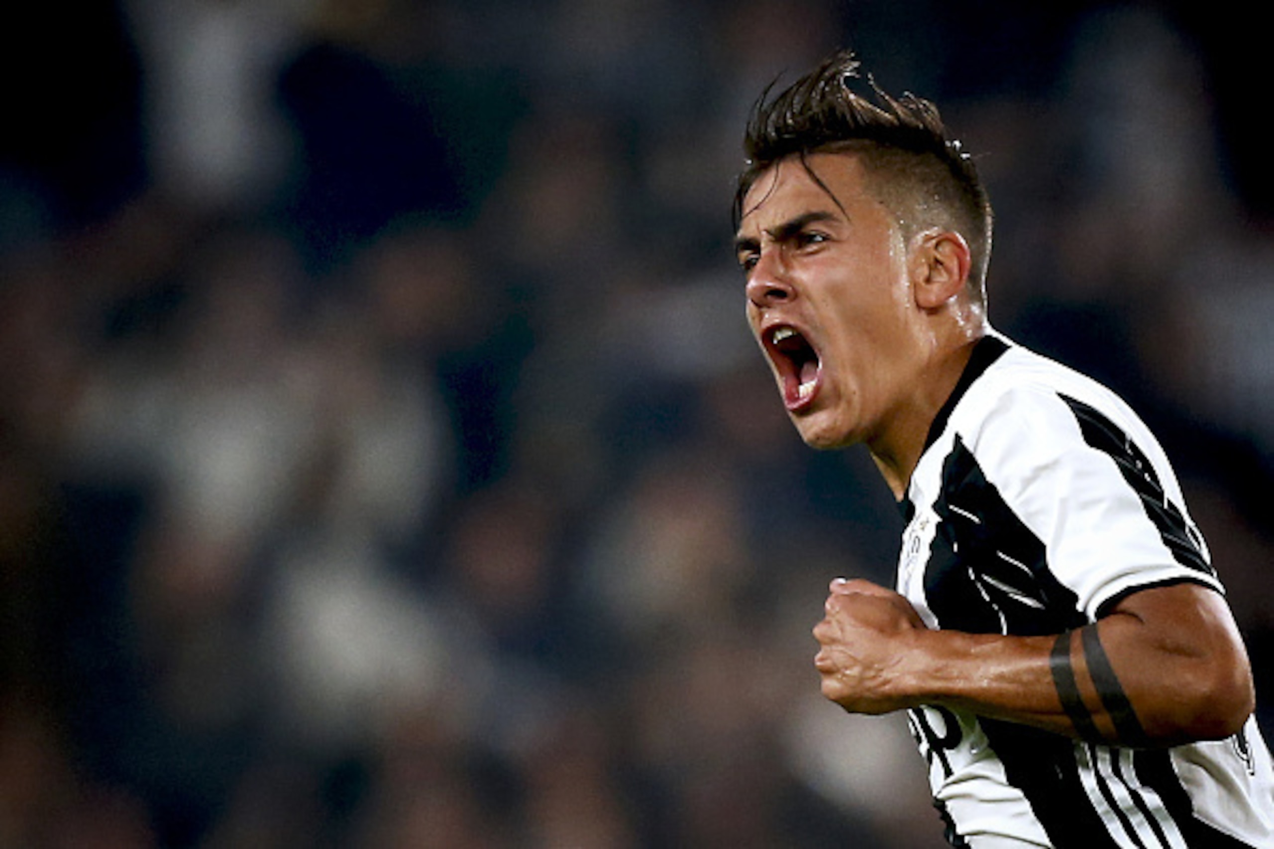 Juventus' forward Paulo Dybala from Argentina celebrates after scoring during the Italian Serie A football match Juventus vs Udinese on October 15, 2016 at the 'Juventus Stadium' in Turin.   / AFP / MARCO BERTORELLO        (Photo credit should read MARCO 