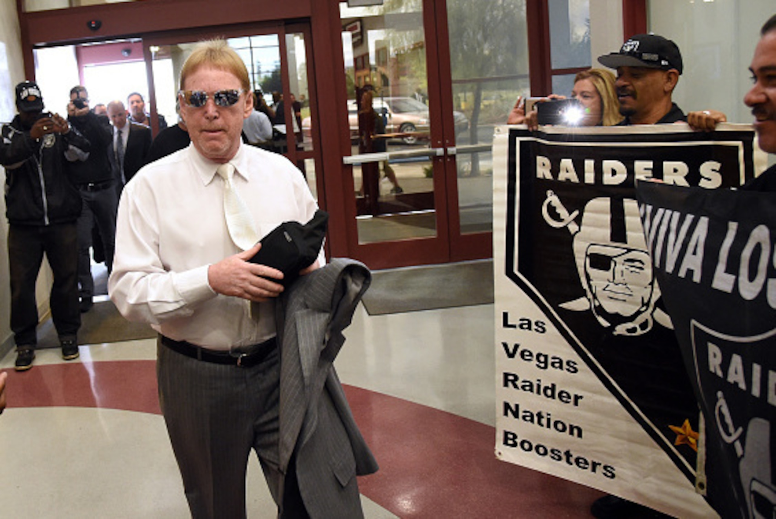 LAS VEGAS, NV - APRIL 28:  Oakland Raiders owner Mark Davis walks past fans holding Raiders signs as he arrives at a Southern Nevada Tourism Infrastructure Committee meeting at UNLV on April 28, 2016 in Las Vegas, Nevada. Davis told the committee he is wi