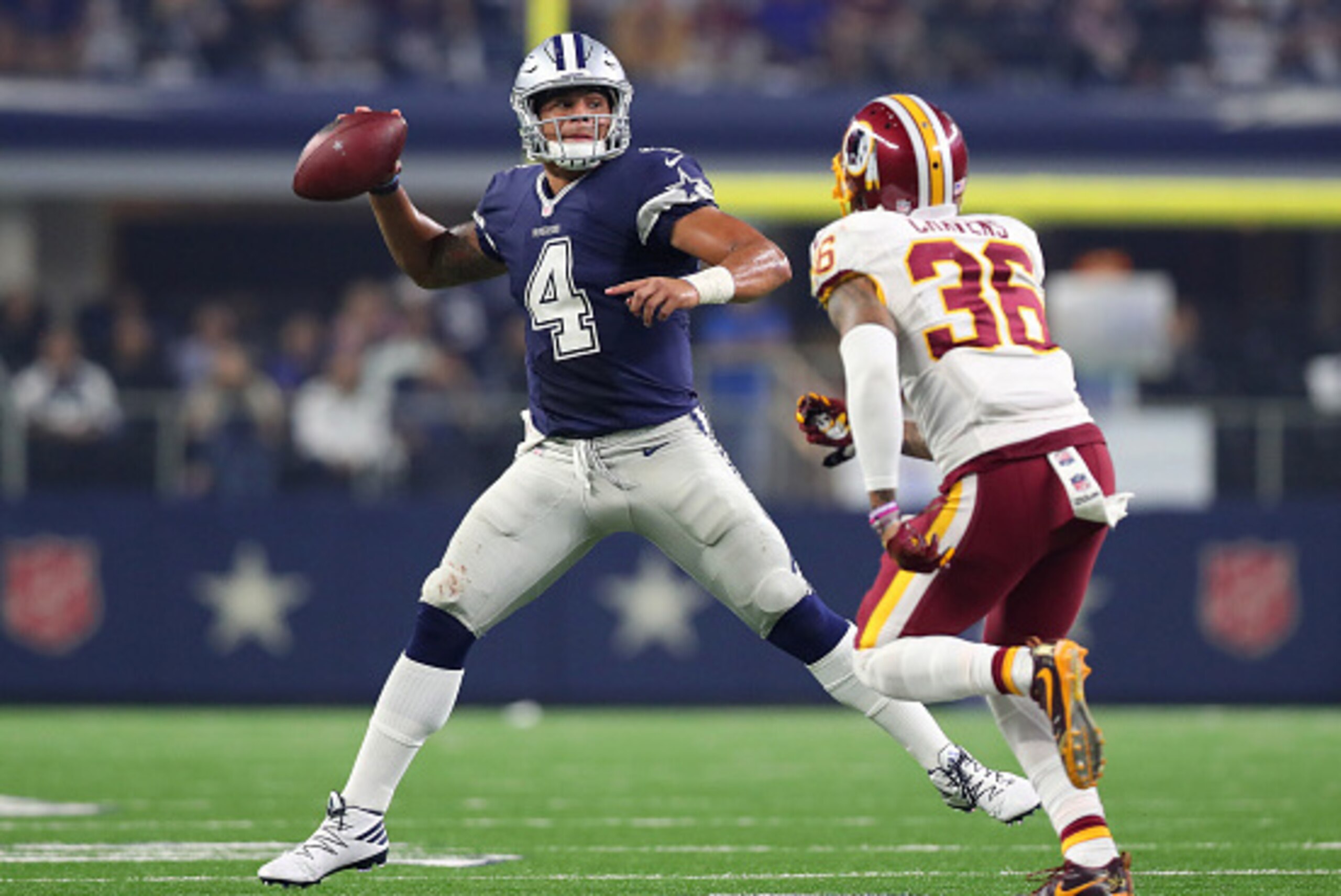 ARLINGTON, TX - NOVEMBER 24:   Dak Prescott #4 of the Dallas Cowboys rolls out to pass during the fourth quarter against the Washington Redskins at AT&T Stadium on November 24, 2016 in Arlington, Texas.  (Photo by Tom Pennington/Getty Images)