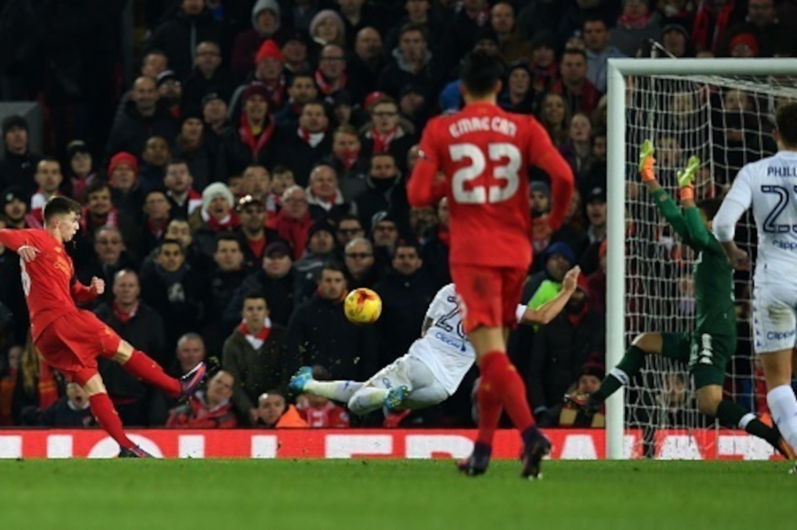 Liverpool's Welsh striker Ben Woodburn (L) scores his team's second goal during the EFL (English Football League) Cup quarter-final football match between Liverpool and Leeds United at Anfield in Liverpool, north west England on November 29, 2016. / AFP /