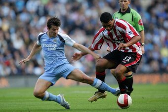 MANCHESTER, UNITED KINGDOM - OCTOBER 14: Colin Kazim-Richards of United Joey Barton of Manchester United in action during the Barclays Premiership match between Manchester City and Sheffield United at The City of Manchester Stadium on October 14, 2006 in 