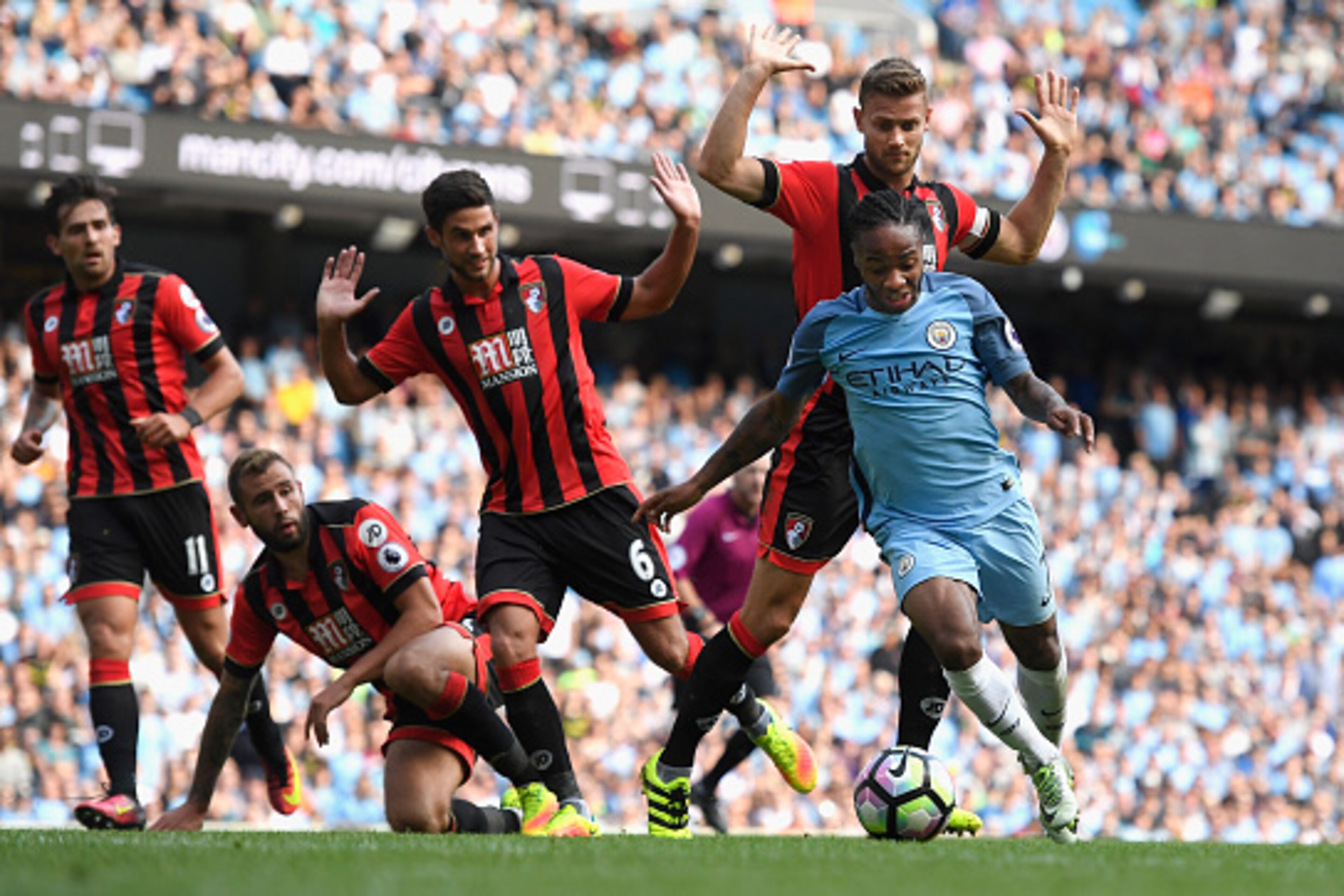 MANCHESTER, ENGLAND - SEPTEMBER 17: Raheem Sterling of Manchester City burst through the AFC Bournemouth defence during the Premier League match between Manchester City and AFC Bournemouth at Etihad Stadium on September 17, 2016 in Manchester, England. MANCHESTER, ENGLAND - SEPTEMBER 17: Raheem Sterling of Manchester City burst through the AFC Bournemouth defence during the Premier League match between Manchester City and AFC Bournemouth at Etihad Stadium on September 17, 2016 in Manchester, England.