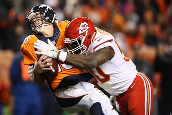 DENVER, CO - NOVEMBER 27:  Outside linebacker Justin Houston #50 of the Kansas City Chiefs sacks quarterback Trevor Siemian #13 of the Denver Broncos for a safety in the second quarter of the game at Sports Authority Field at Mile High on November 27, 201