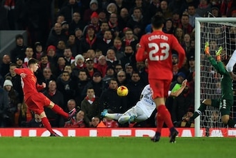 Liverpool's Welsh striker Ben Woodburn (L) scores his team's second goal during the EFL (English Football League) Cup quarter-final football match between Liverpool and Leeds United at Anfield in Liverpool, north west England on November 29, 2016. / AFP /