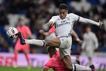 Real Madrid's forward Mariano (L) vies with Cultural Leonesa's defender Angel Bastos during the Spanish Copa del Rey (King's Cup) Round of 32 second leg football match Real Madrid CF vs Cultural y Deportiva Leonesa at the Santiago Bernabeu stadium in Madr