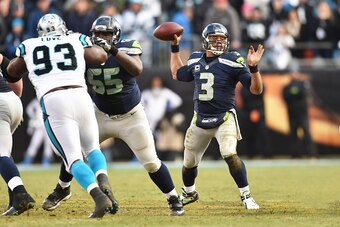 CHARLOTTE, NC - JANUARY 17:  Quarterback Russell Wilson #3 of the Seattle Seahawks passes during the NFC Divisional Playoff Game against the Carolina Panthers at Bank of America Stadium on January 17, 2016 in Charlotte, North Carolina.  (Photo by Ronald C