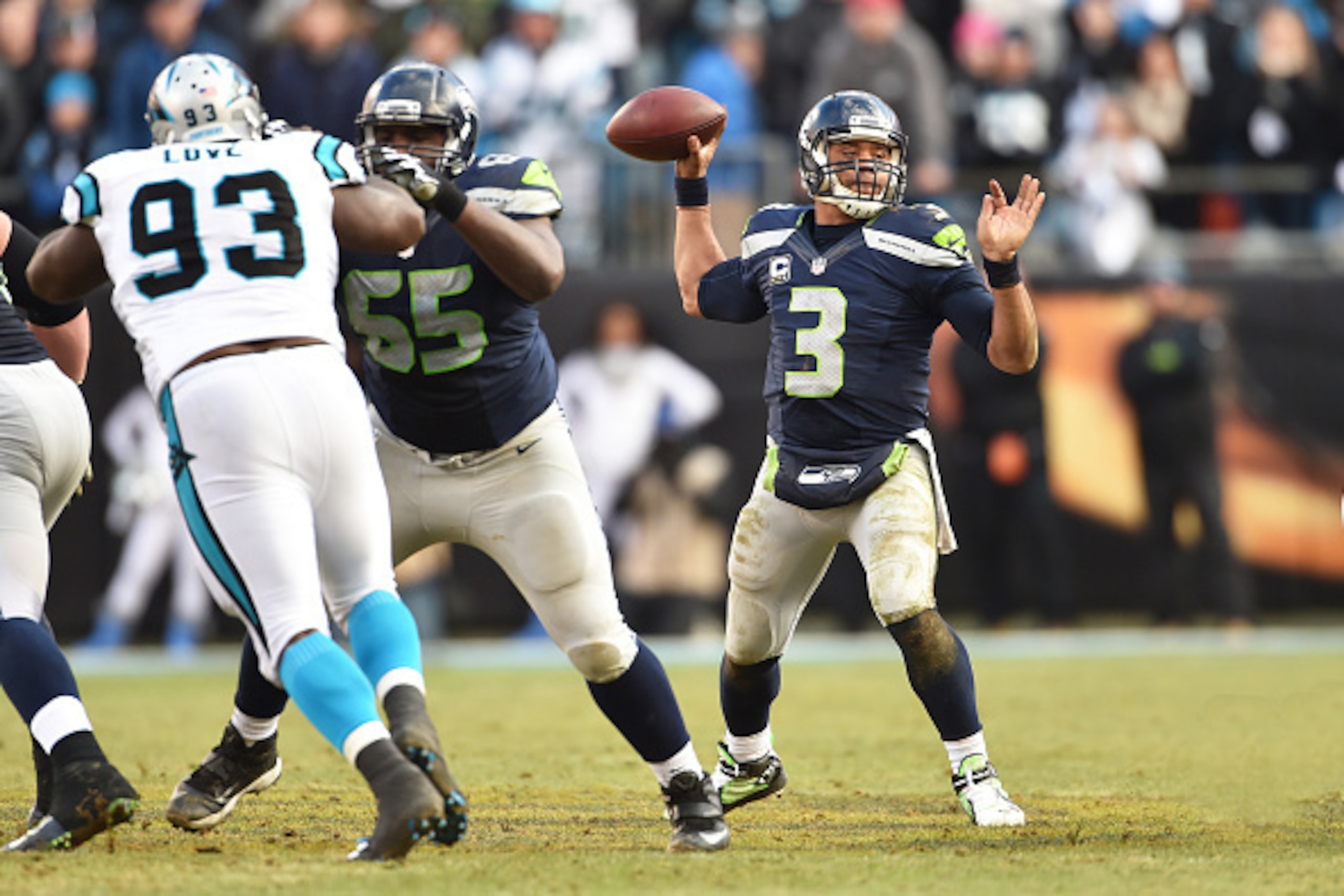 CHARLOTTE, NC - JANUARY 17:  Quarterback Russell Wilson #3 of the Seattle Seahawks passes during the NFC Divisional Playoff Game against the Carolina Panthers at Bank of America Stadium on January 17, 2016 in Charlotte, North Carolina.  (Photo by Ronald C