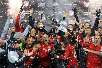 TORONTO, ON - NOVEMBER 30:  Michael Bradley #4 of Toronto FC and teammates celebrate with the Eastern Conference Trophy following the MLS Eastern Conference Final, Leg 2 game against Montreal Impact at BMO Field on November 30, 2016 in Toronto, Ontario, C