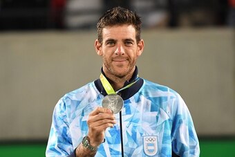 Silver medallist Argentina's Juan Martin Del Potro poses on the podium of the men's singles gold medal tennis event at the Olympic Tennis Centre of the Rio 2016 Olympic Games in Rio de Janeiro on August 14, 2016. / AFP / Luis Acosta        (Photo credit s