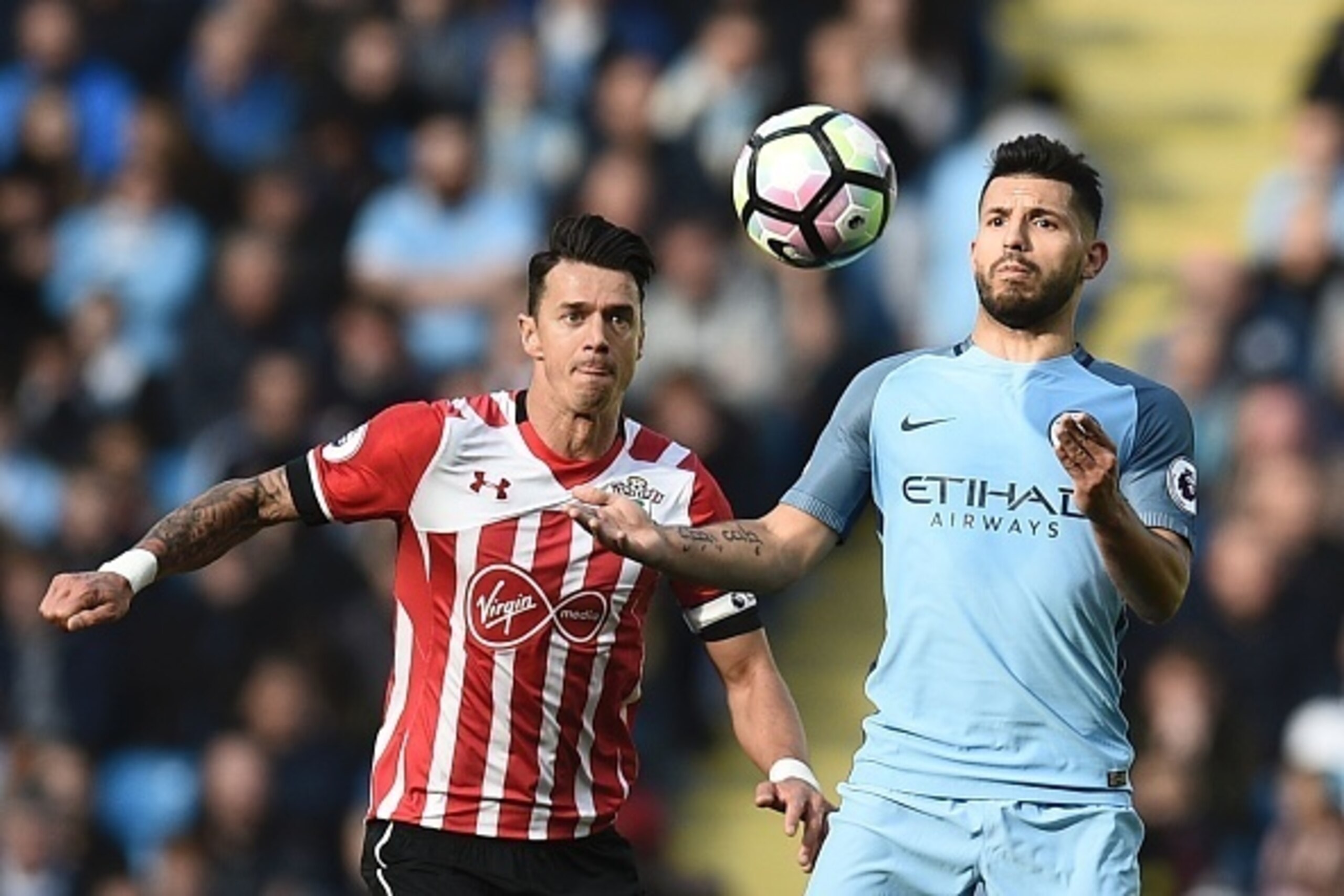 Manchester City's Argentinian striker Sergio Aguero (R) vies with Southampton's Portuguese defender Jose Fonte during the English Premier League football match between Manchester City and Southampton at the Etihad Stadium in Manchester, north west England