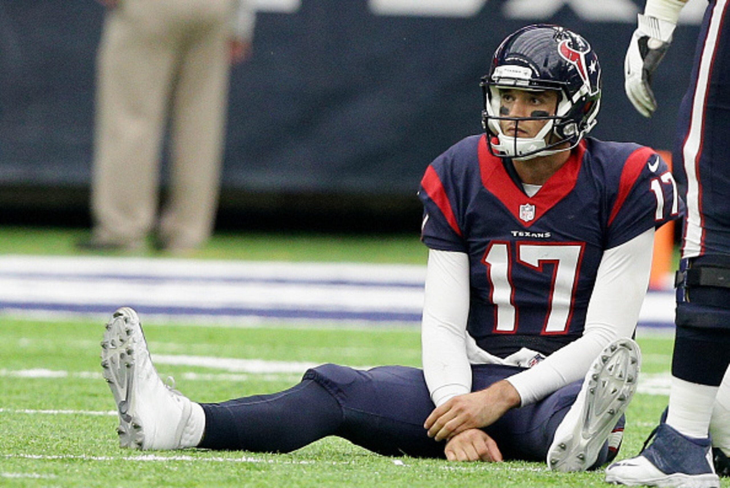 HOUSTON, TX - NOVEMBER 27: Brock Osweiler #17 of the Houston Texans sits on the field after being tripped up by Joey Bosa #99 of the San Diego Chargers  at NRG Stadium on November 27, 2016 in Houston, Texas.  (Photo by Bob Levey/Getty Images)
