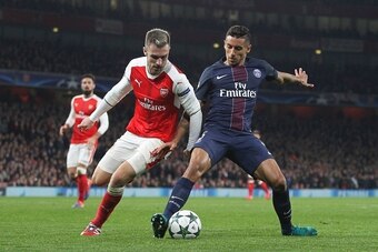 Arsenal's Welsh midfielder Aaron Ramsey (L) challenges Paris Saint-Germain's Brazilian defender Marquinhos (R) during the UEFA Champions League group A football match between Arsenal and Paris Saint-Germain at the Emirates Stadium in London on November 23