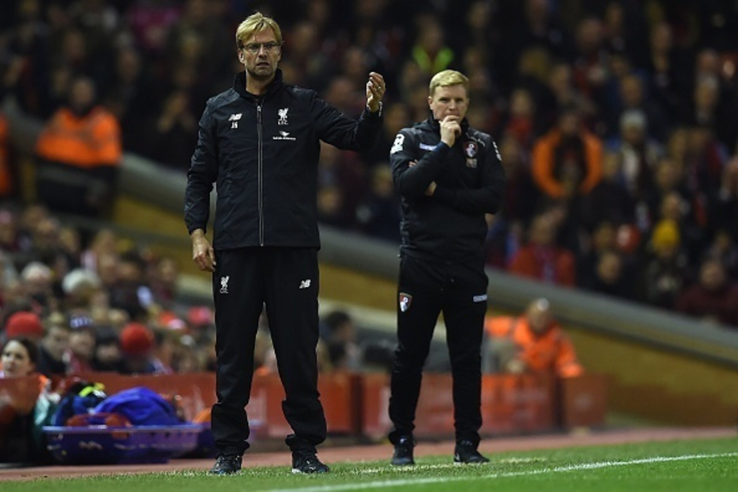 Liverpool's German manager Jurgen Klopp (L) and Bournemouth's English manager Eddie Howe watch their players during the English League Cup fourth round football match between Liverpool and Bournemouth at Anfield stadium in Liverpool, north west England on