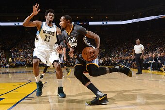 OAKLAND, CA - NOVEMBER 26:  Kevin Durant #35 of the Golden State Warriors drives to the basket against Andrew Wiggins #22 of the Minnesota Timberwolves during a game on November 26, 2016 at ORACLE Arena in Oakland, California. NOTE TO USER: User expressly