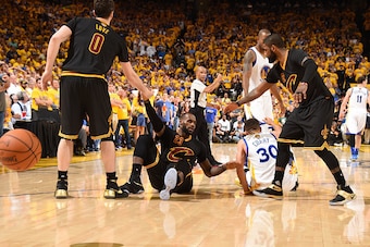 OAKLAND, CA - JUNE 19:  Kevin Love #0 and Kyrie Irving #2 help pick up LeBron James #23 of the Cleveland Cavaliers during the game against the Golden State Warriors in Game Seven of the 2016 NBA Finals on June 19, 2016 at ORACLE Arena in Oakland, Californ