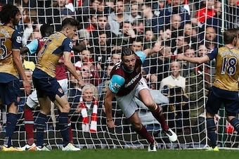 West Ham United's English striker Andy Carroll (2R) celebrates scoring his team's second goal during the English Premier League football match between West Ham United and Arsenal at The Boleyn Ground in Upton Park, in east London on April 9, 2016. / AFP /