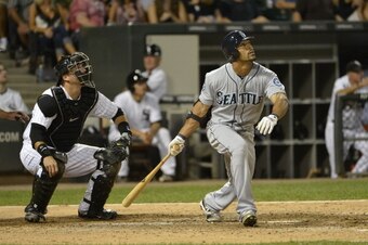 CHICAGO, IL - AUGUST 24:  Eric Thames #10 of the Seattle Mariners (R) bats as A.J. Pierzynski #12 of the Chicago White Sox catches at U.S. Cellular Field on August 24, 2012 in Chicago, Illinois. The White Sox defeated the Mariners 9-8.  (Photo by Brian D.